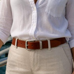 WOMAN IN A MARINA WEARING A FULL GRAIN LEATHER BELT IN DARK TAN COLOUR